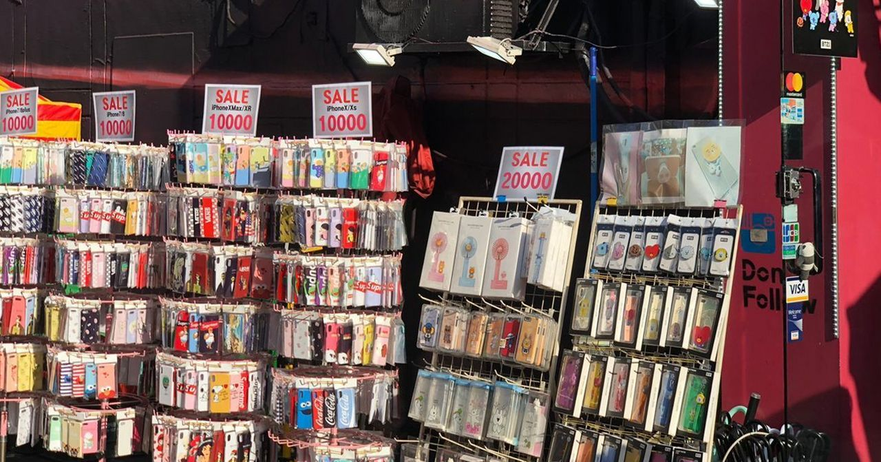 Display of various phone cases for sale in Hongdae alley in Seoul, emphasizing local business offerings.