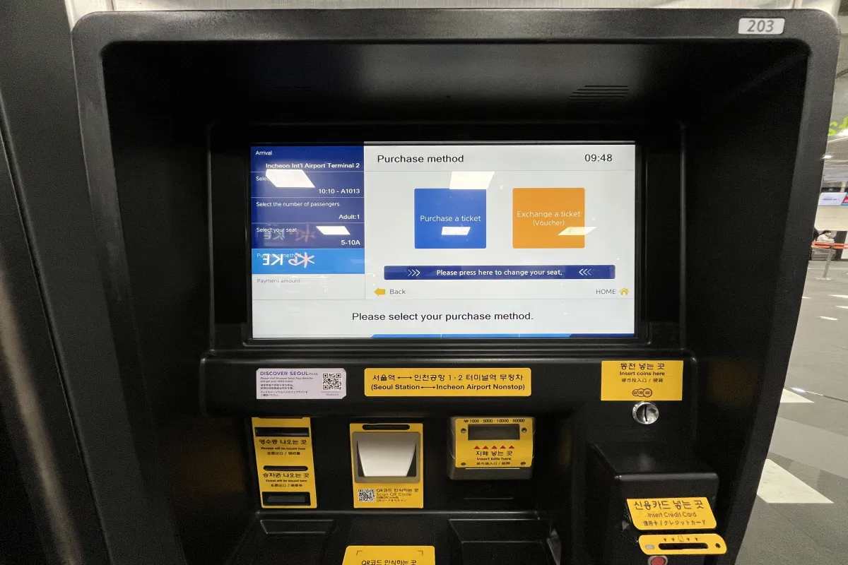 AREX ticket purchase screen on vending machine, highlighting exchange voucher option for ticket acquisition.AREX Ticket kiosk at Seoul Station seat selection screen