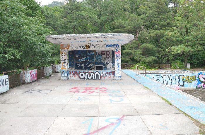 Butterfly resting on the ground at the abandoned swimming pool, symbolizing beauty in decay.