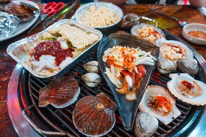 Delicious grilled seafood dish with various toppings served on the coast.