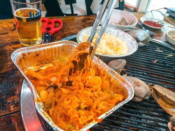 Grilled scallops and seafood freshly prepared on the beach.