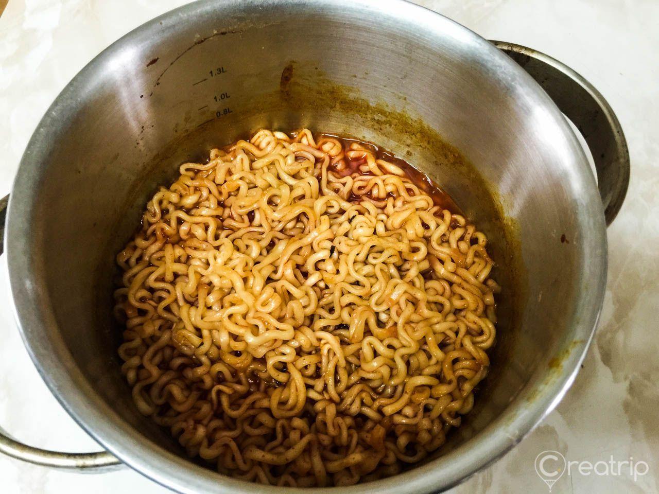 再次加熱鍋中的辣炒雞麵，煮至湯汁更加濃縮，為了讓面條更入味，簡單的小竅門。