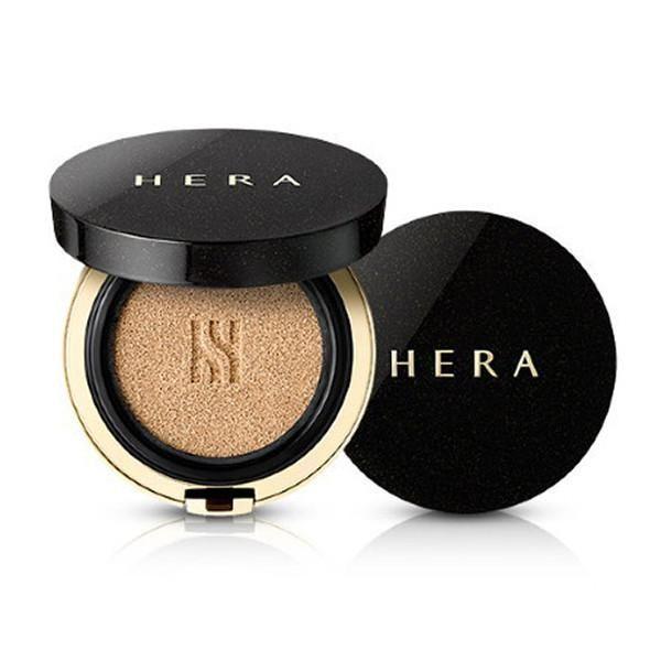 HERA black cushion in its opened state, highlighting the compact and applicator puff.