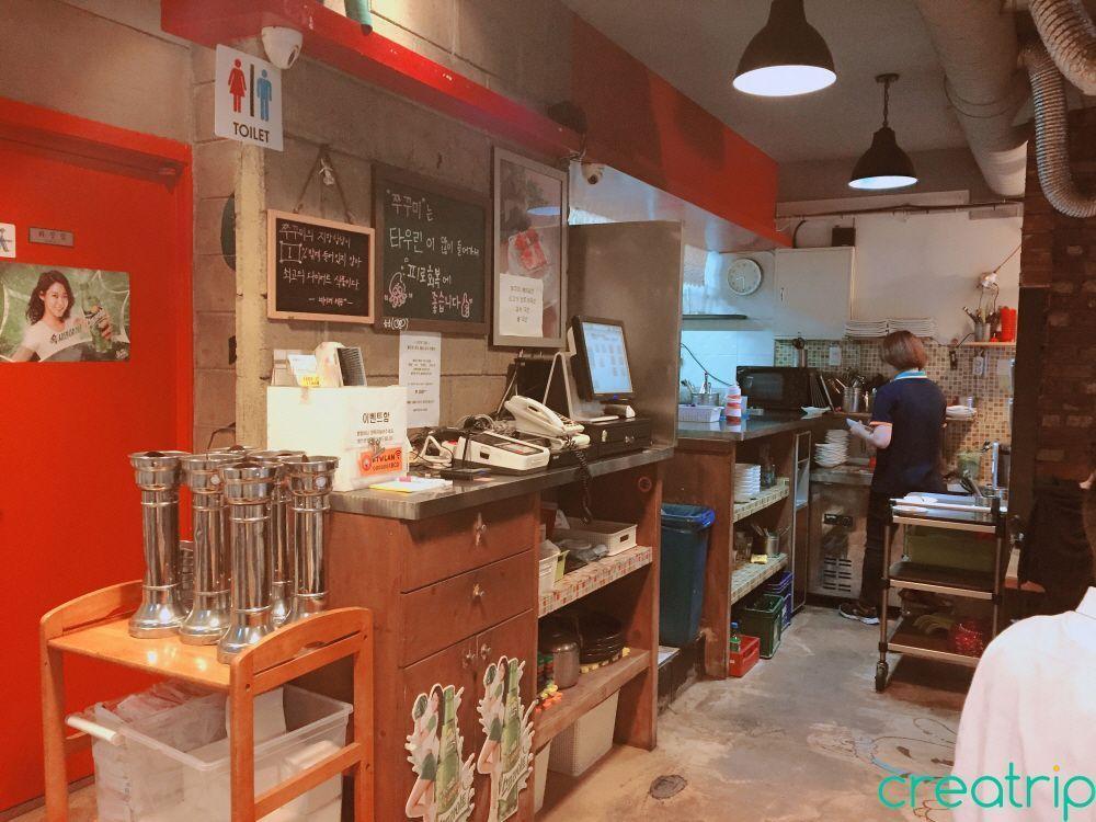 Counter inside Fatty Octopus restaurant in Myeongdong, with staff ready to assist customers.
