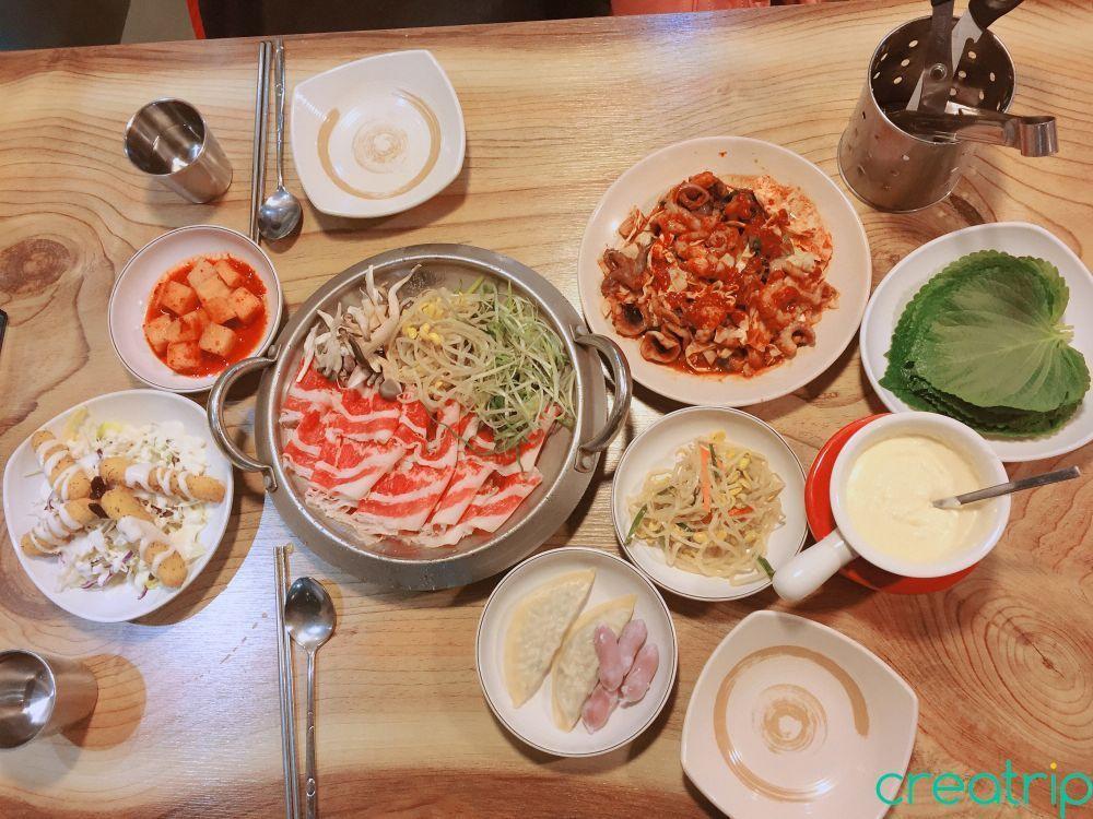 Platter with small beef slices, octopus, dumplings, salad, cheddar cheese, and pickled radish served at Fatty Octopus restaurant.