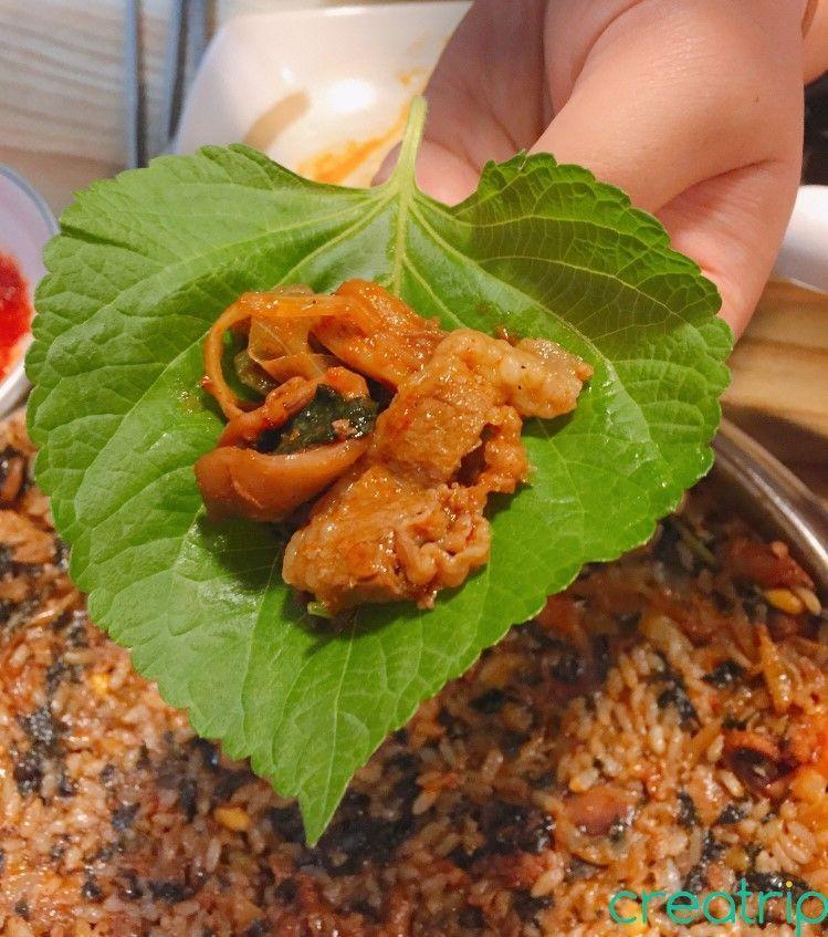Small beef slices and octopus wrapped in perilla leaf at Fatty Octopus restaurant for a flavorful bite.