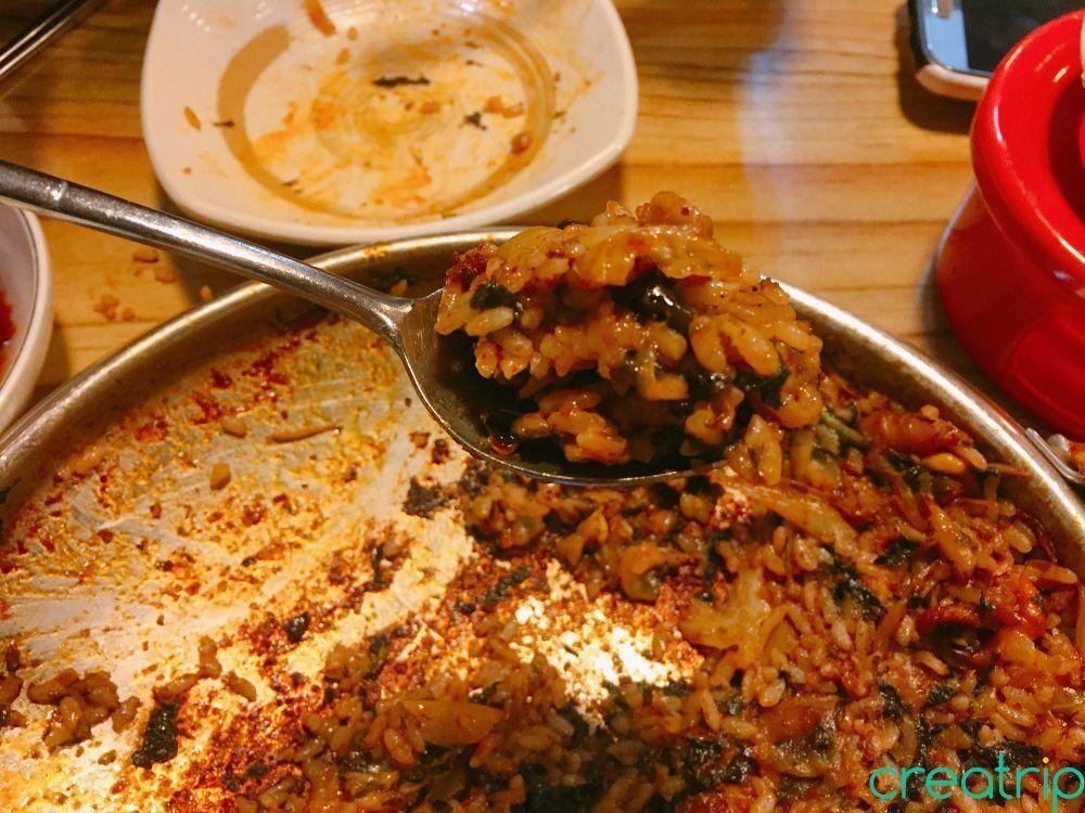 Fried rice cooked at Fatty Octopus restaurant, shown with garnishing on the side.