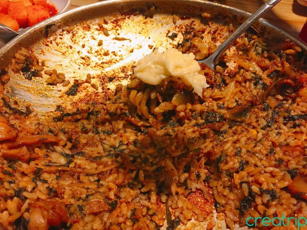 Fried rice topped with cheese from Fatty Octopus restaurant, creating an extra delightful dish.