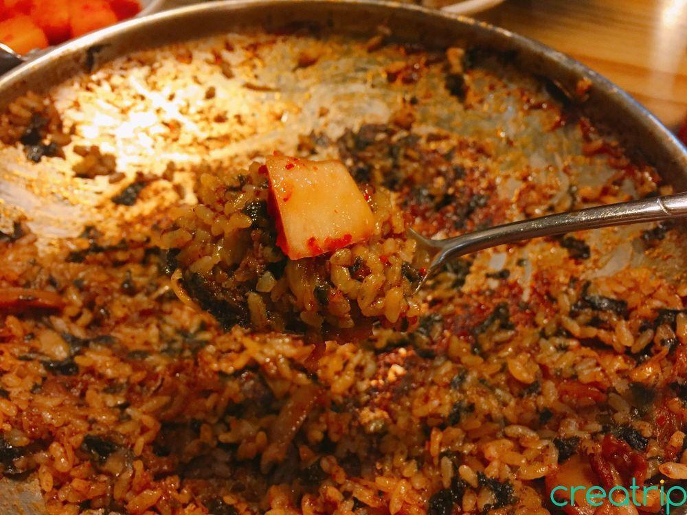 Fried rice at Fatty Octopus restaurant served with crunchy radish kimchi for a unique texture.