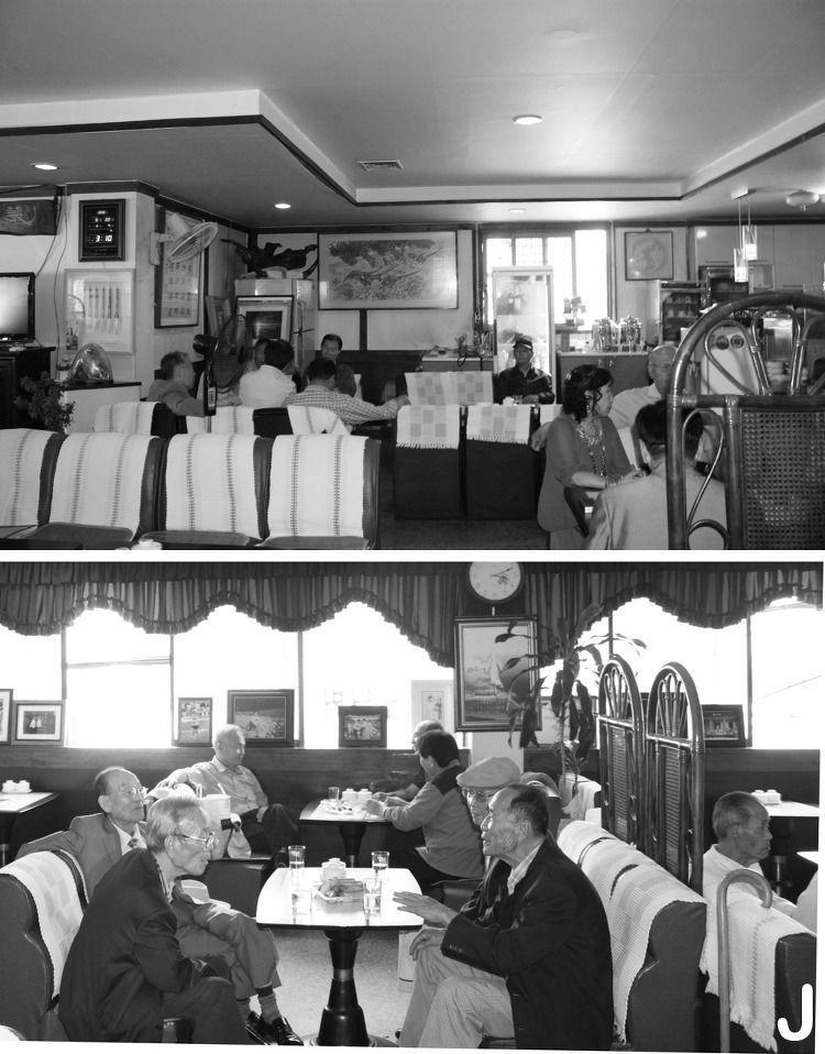 Black and white photo depicting a traditional Dabang, a historical Korean teahouse with patrons enjoying tea.