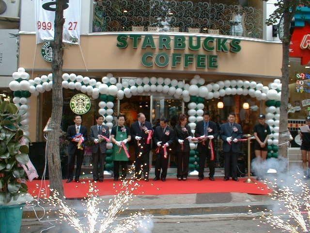Grand opening ceremony of the first Starbucks in Korea, emphasizing the influence of global coffee culture.