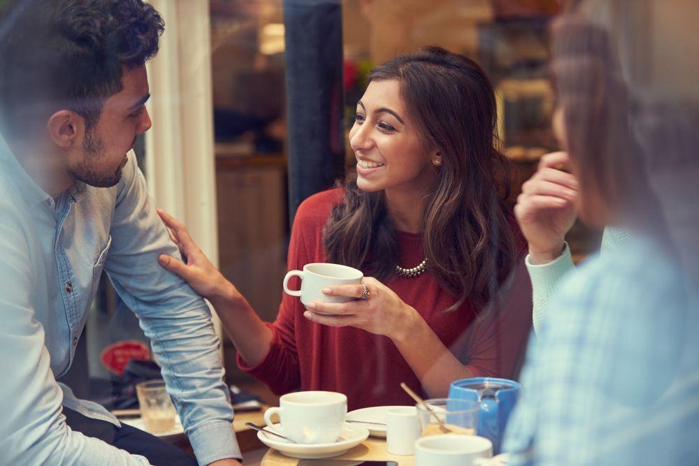 Close-up of a group at a modern cafe, highlighting the social aspect of coffee culture in South Korea.