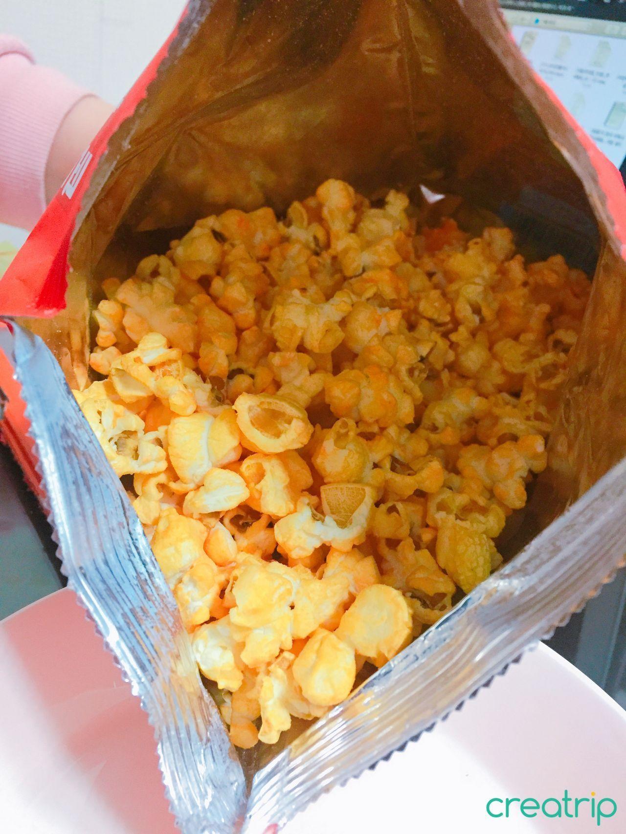 Bold and spicy Flame Popcorn coated in enticing reddish seasoning.