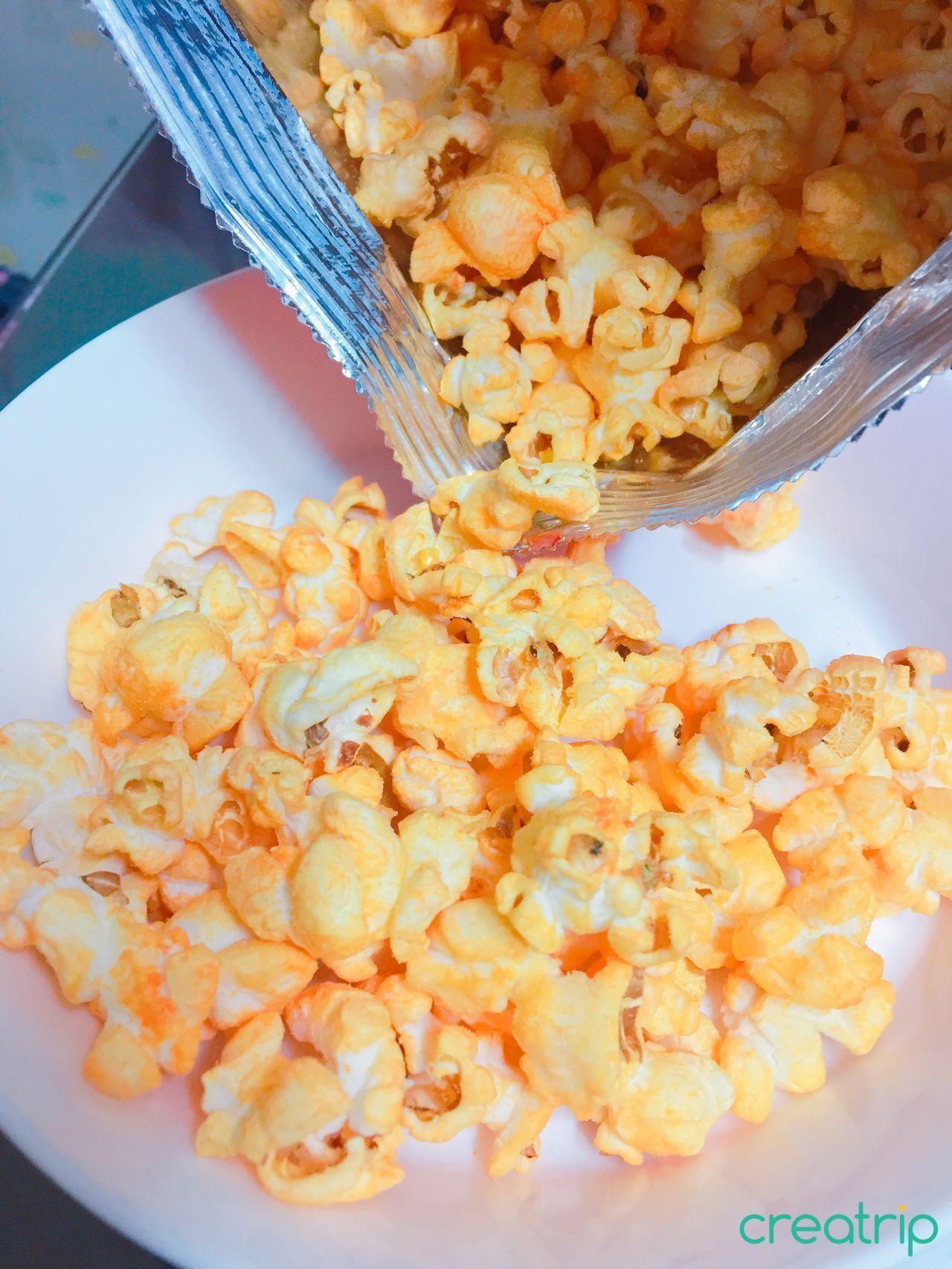Plentiful Flame Popcorn in a light bowl, highlighting its vibrant hue and flavorful promise.
