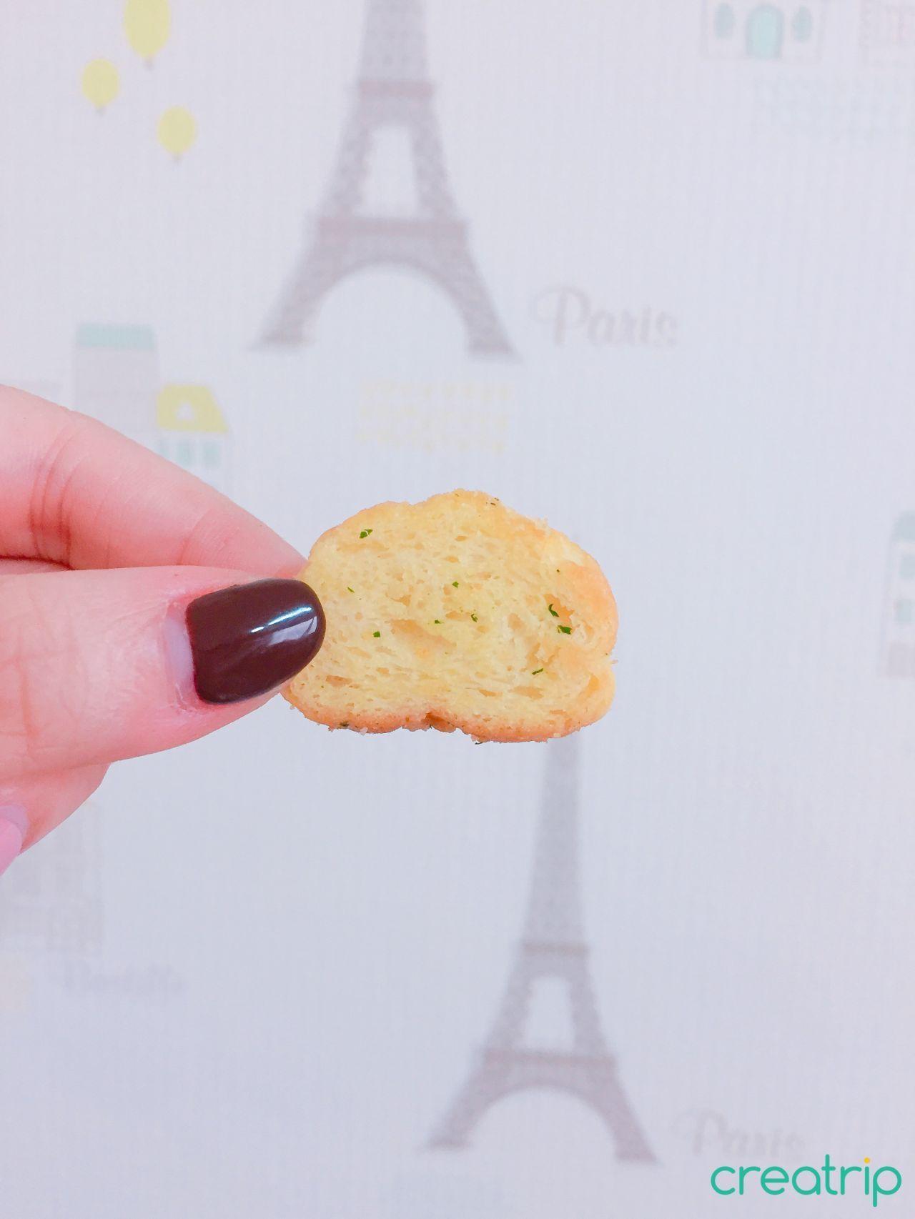 A piece of Garlic Bread Snack showcases satisfying crunch and distinct garlic seasoning.
