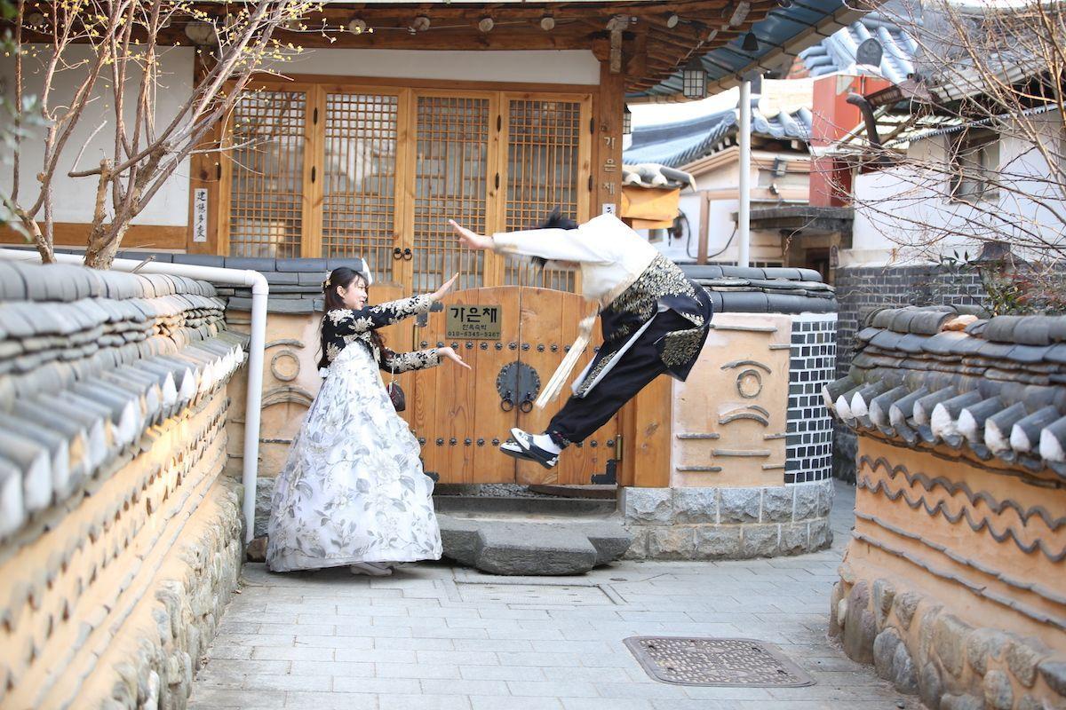 Tourist in Hanbok in front of a historical building in Jeonju, encapsulating the essence of Korean culture.
