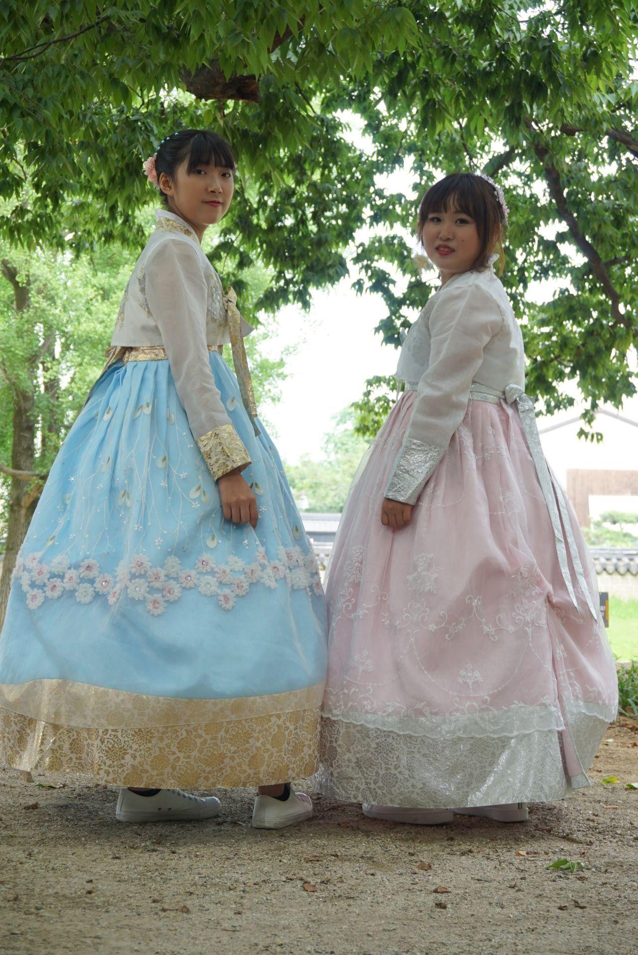 Women posing in traditional Hanbok at a Jeonju attraction, capturing memorable moments in cultural wear.