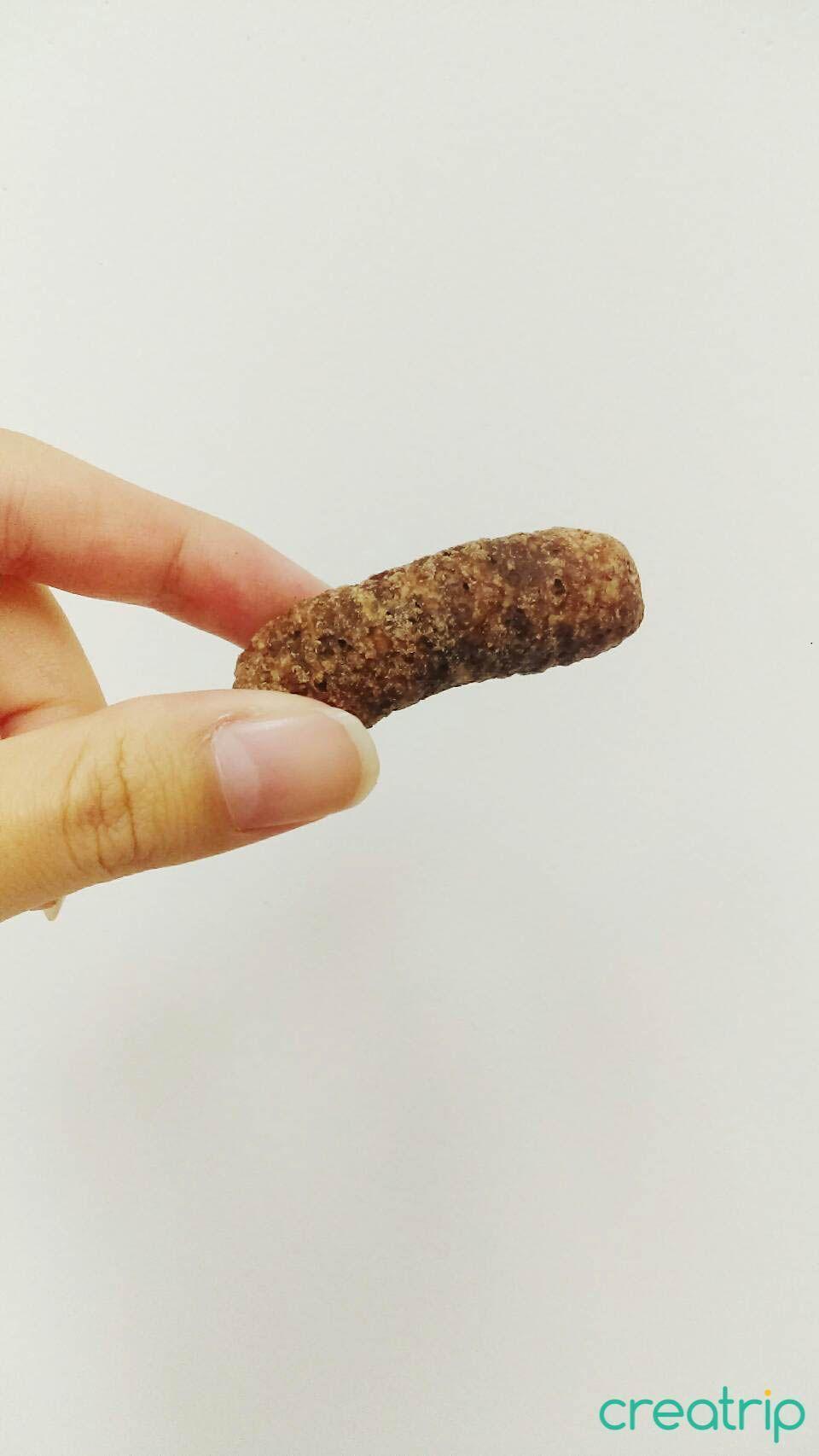Hand holding a single chocolate corn snack from CU Korean convenience store product