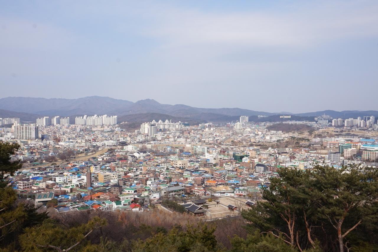 西將臺展望臺上俯瞰水原市的重點全景，天空晴朗，遠處的山峰和藍天完美融合。