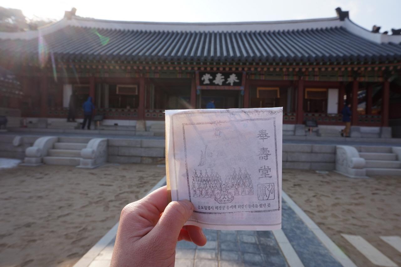 在華城行宮內的印章收集體驗遊玩者手持蓋章本的特寫。