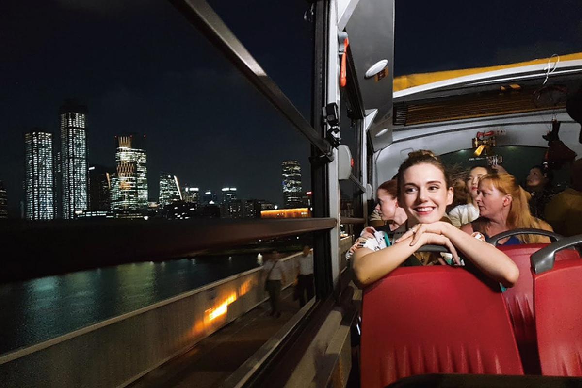Seoul City Tour Bus at Yeouido, highlighting the night skyline with reflections on the Han River