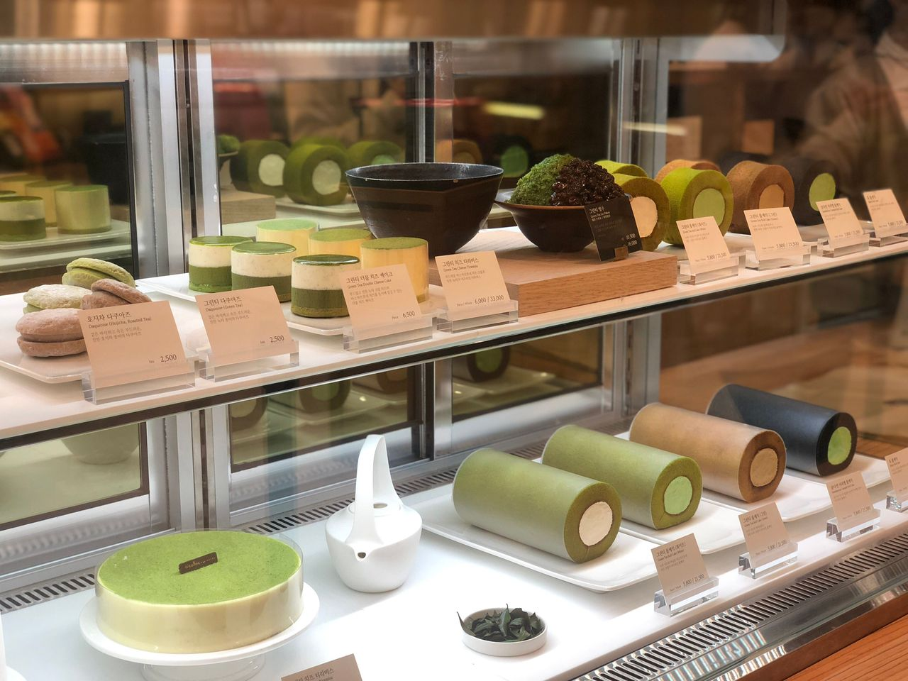 Display case showcasing a variety of matcha desserts at O