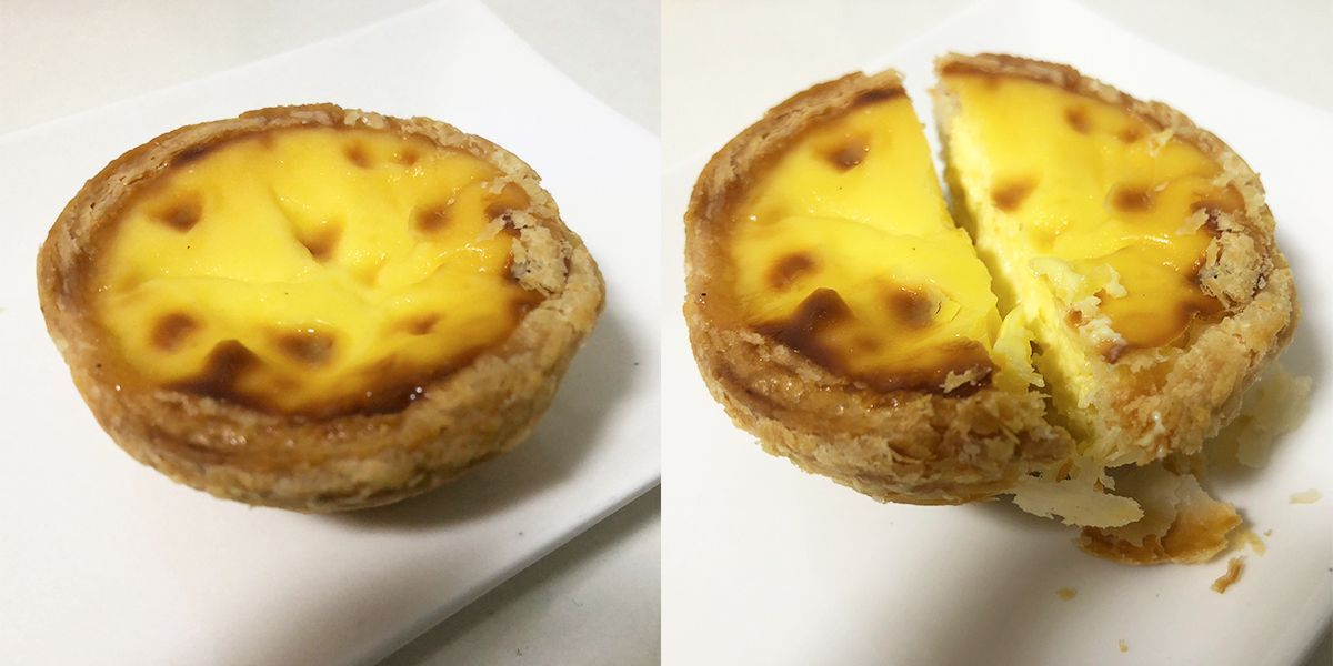 Portuguese egg tart cut open showing the creamy filling at Pastel de Nata