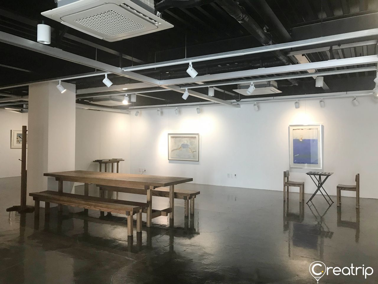 Interior of Cafe 88st gallery space showing minimalist décor and art