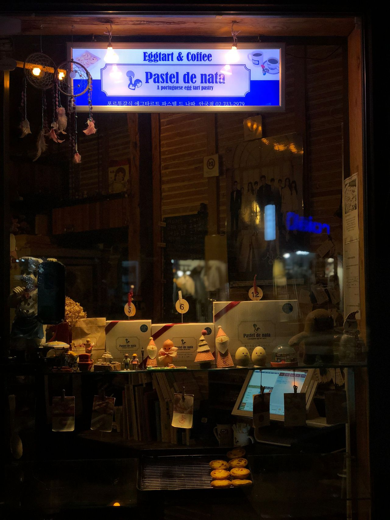 Interior view of Pastel de Nata café with decor and pastries on display