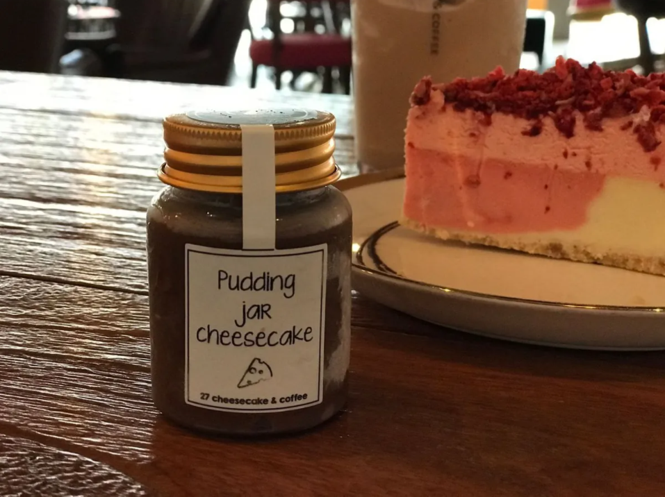 Detailed view of C27's unique pudding jar cheesecake, adding a creative twist to traditional cheesecake.