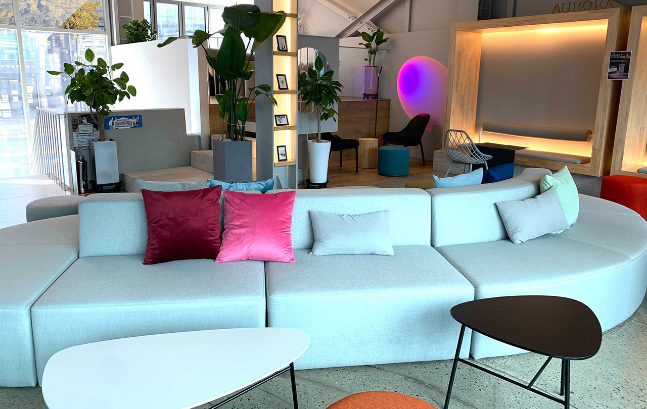 Stylish and colorful interior of Cafe Aurora, featuring modern seating and decorative lighting.