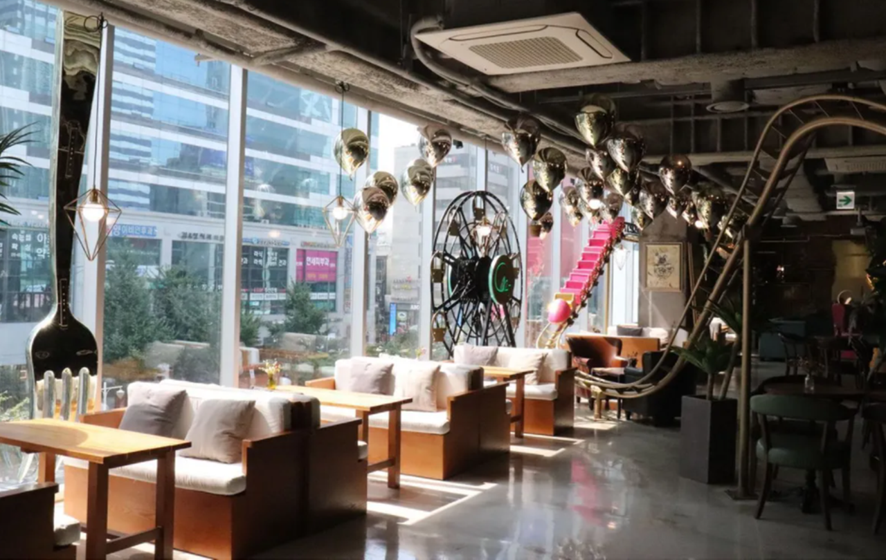 Quirky and playful interior of C27, highlighting oversized decor and fun seating arrangements.