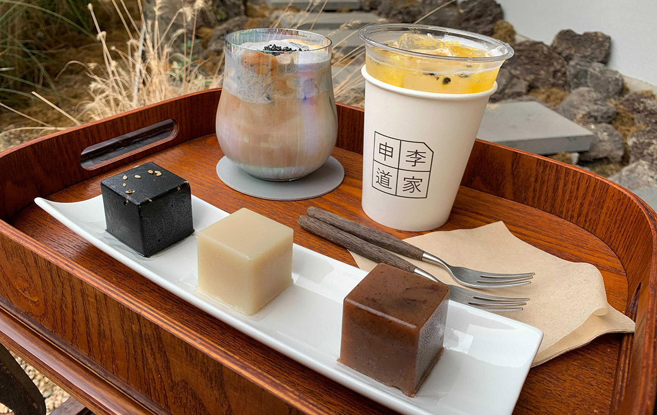 Black Sesame Latte, Passion Fruit Juice, and three Yokan cakes elegantly served on a tray, capturing Shinidoga's blend of Korean and modern flavors.