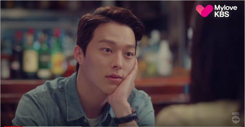 Korean drama scene depicting a couple sitting together at a bar, focusing on their body language and ambiance.