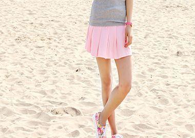 Person standing on the sand in fashionable attire, symbolizing contemporary Korean fashion.