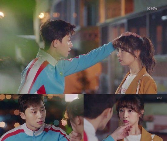 Korean drama scene depicting gentle gestures between characters, showcasing human connection.