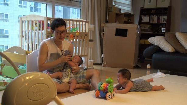 Young father caring for children, indicating evolving parenting roles in Korea.