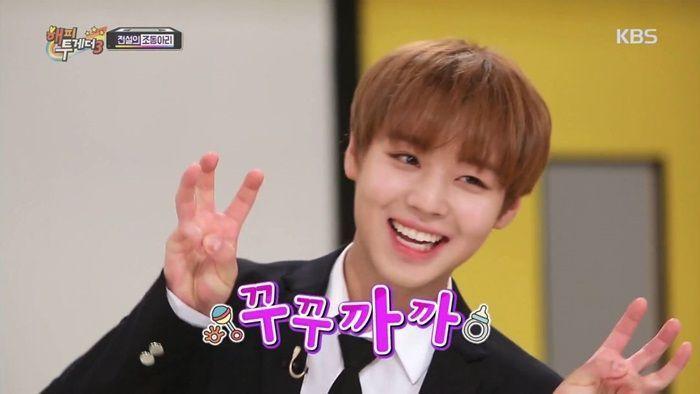 Korean TV show scene with a person making a peace sign, representing typical TV show gestures.