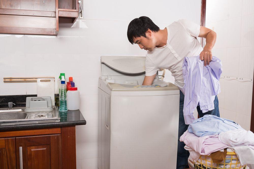 Man performing household chores, symbolizing changing gender roles in Korean families.