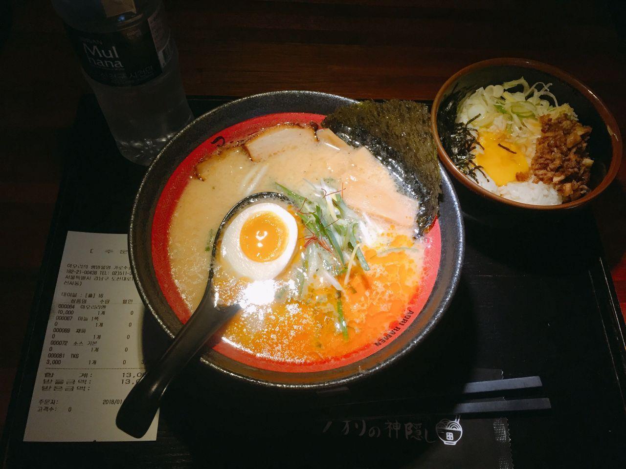 A table with dishes at Aori Ramen including ramen and TKG