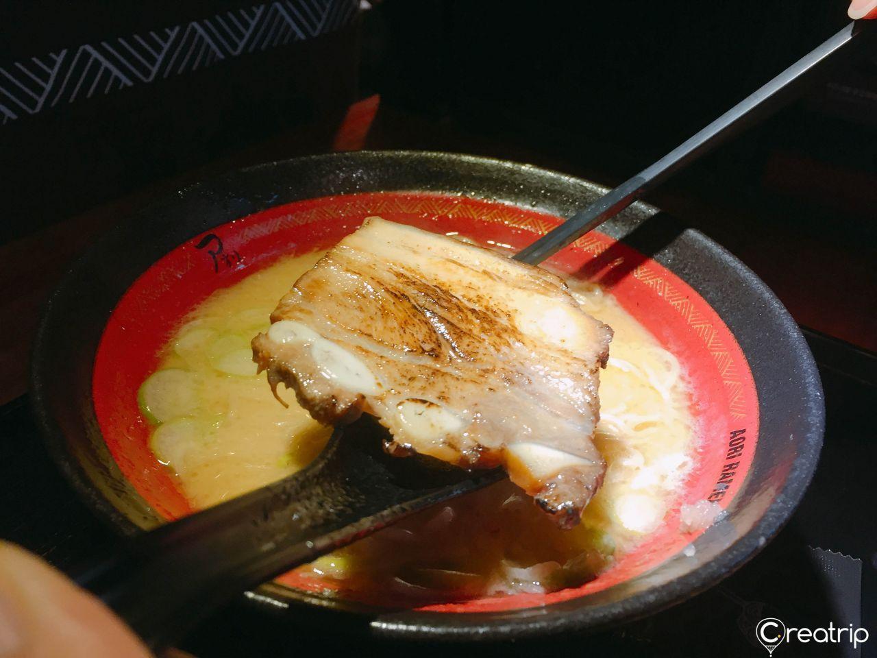 Detailed image of chargrilled meat served in Aori Ramen