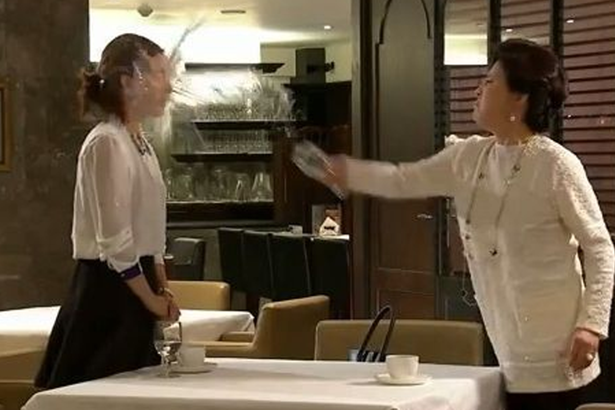 A Korean drama scene highlighting a confrontation in a dining setting.