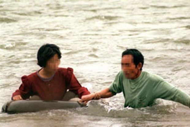 Silhouette of a running figure against the North Korean flag symbolizing escape efforts