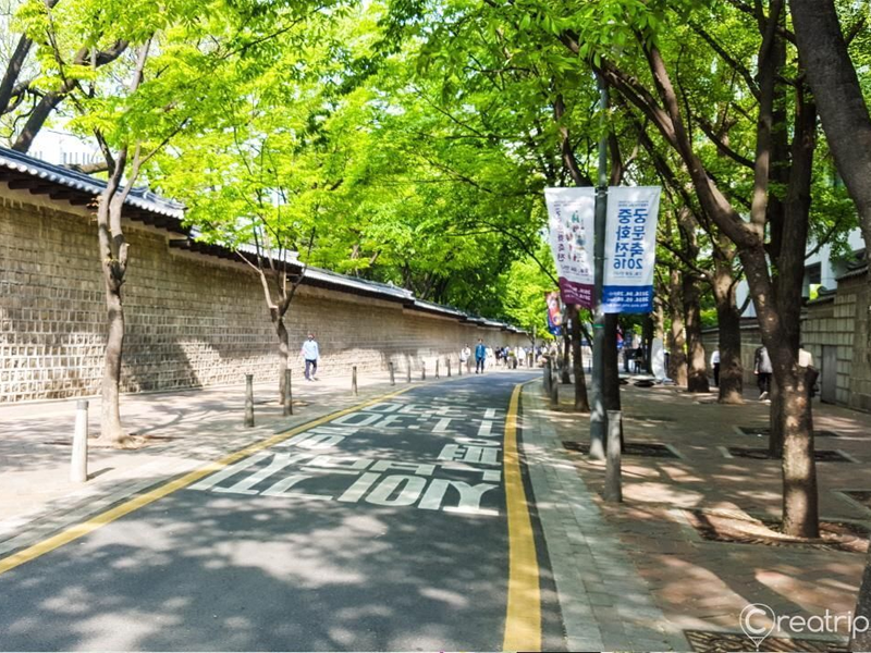 road along stone wall of deoksugung palace in seoul