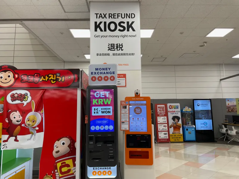 Tax refund kiosk in Homeplus Seoul reminding tourists of quick and easy tax rebate options, alongside currency exchange services.
