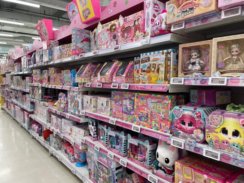 Ashopping aisle in Homeplus Seoul filled with colorful children’s toys and games, demonstrating the variety of products available.