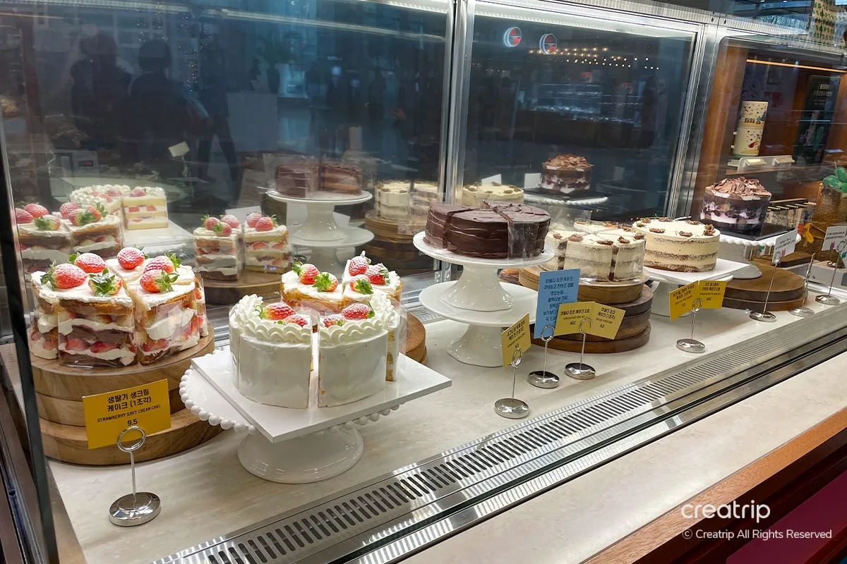 Display of assorted pastry and cakes at COLECTIVO Cafe, including enticing strawberry shortcake and chocolate earl grey fig cakes.