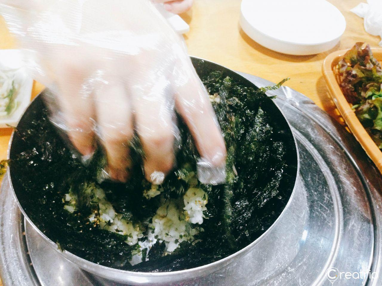 A metal bowl filled with seasoned seaweed in preparation for making Korean rice balls at the restaurant.