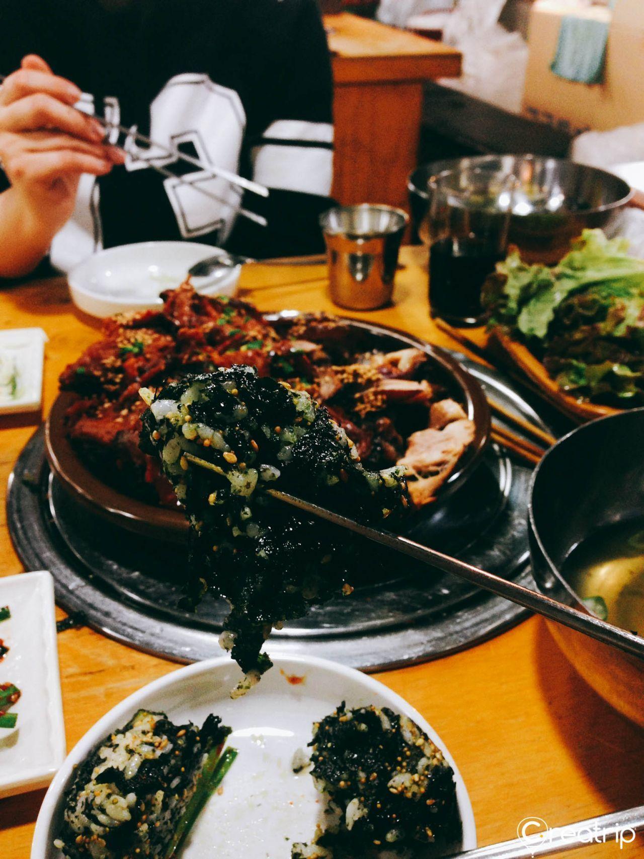 Plate of homemade Korean rice balls wrapped in seaweed, showcasing a staple side at Jokbal restaurant.