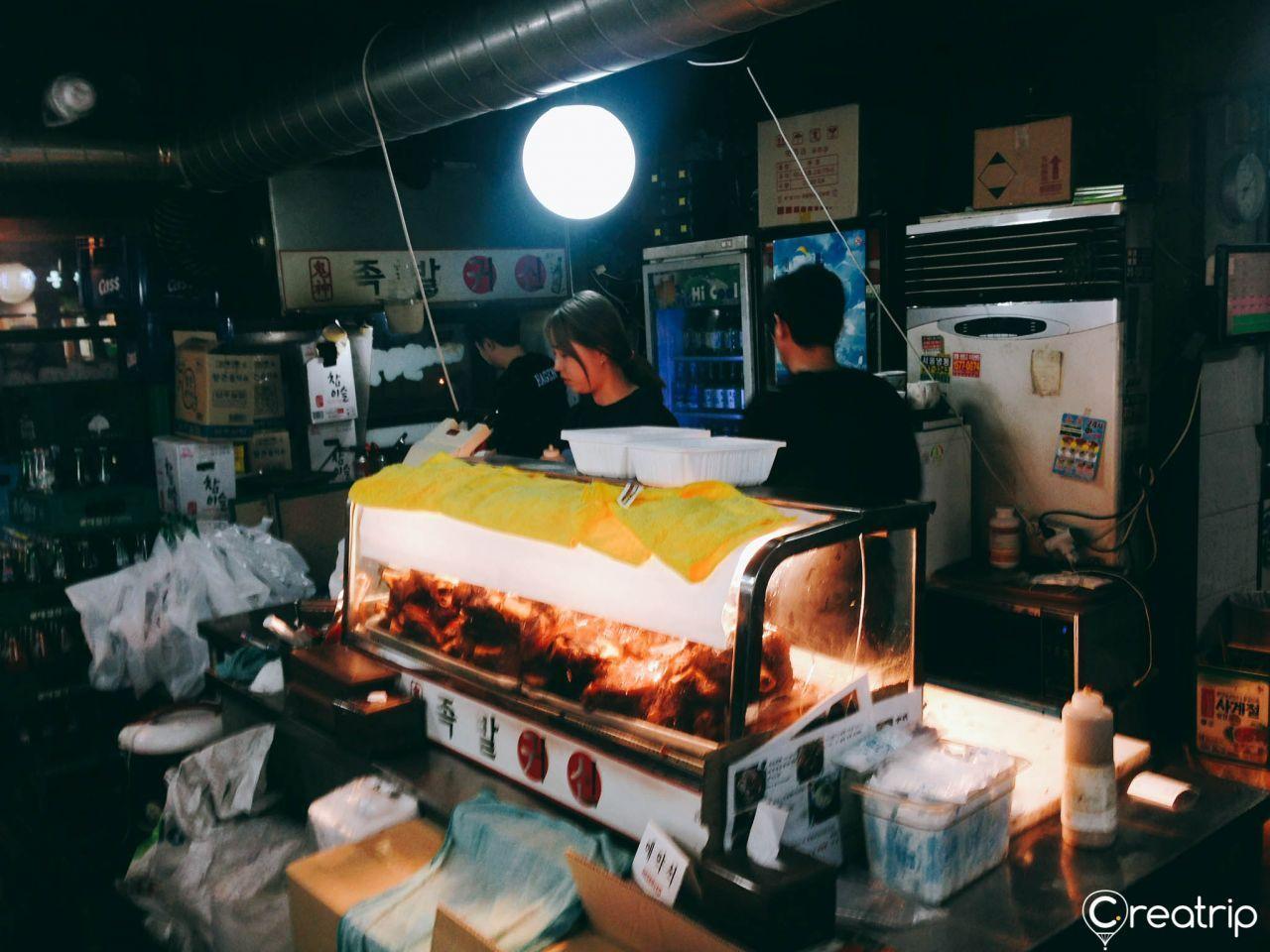 An informative poster inside Jokbal restaurant promoting events and special offers for customers.